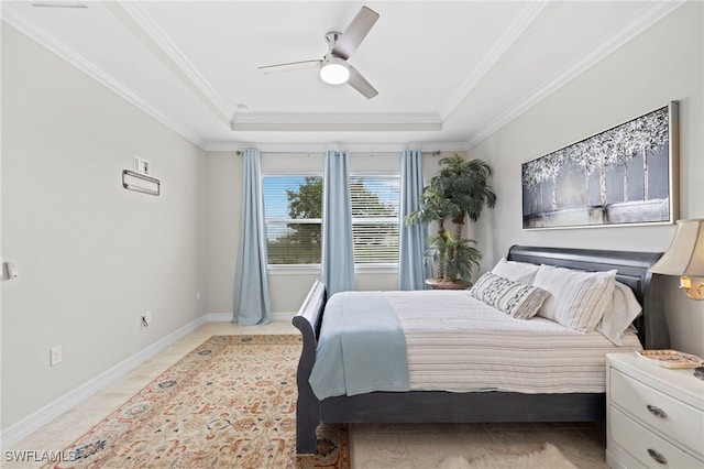 bedroom with ceiling fan, a raised ceiling, and ornamental molding