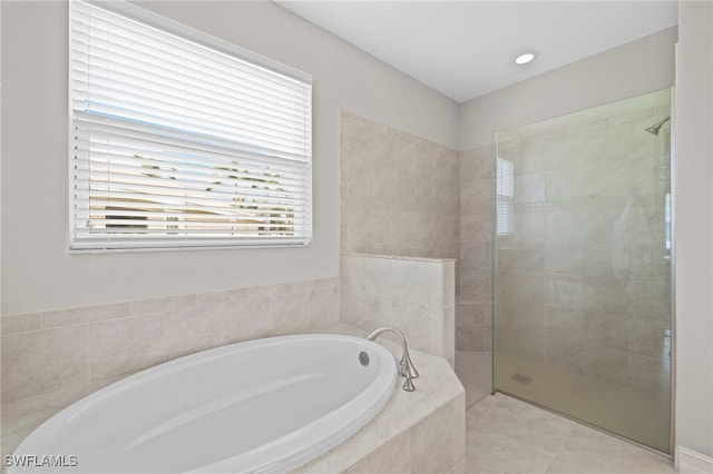 bathroom featuring separate shower and tub, tile patterned floors, and a healthy amount of sunlight