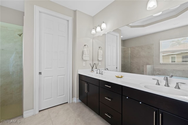 bathroom with tile patterned floors, vanity, a tray ceiling, crown molding, and tiled shower