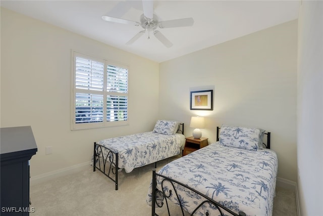 bedroom featuring ceiling fan and light carpet