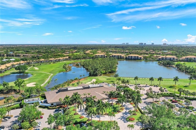 aerial view with golf course view and a water view