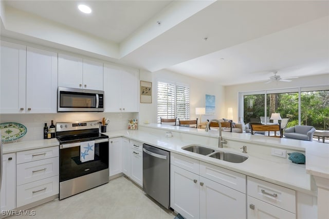 kitchen featuring white cabinets, appliances with stainless steel finishes, and sink