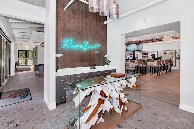 dining area with a high ceiling and light parquet flooring