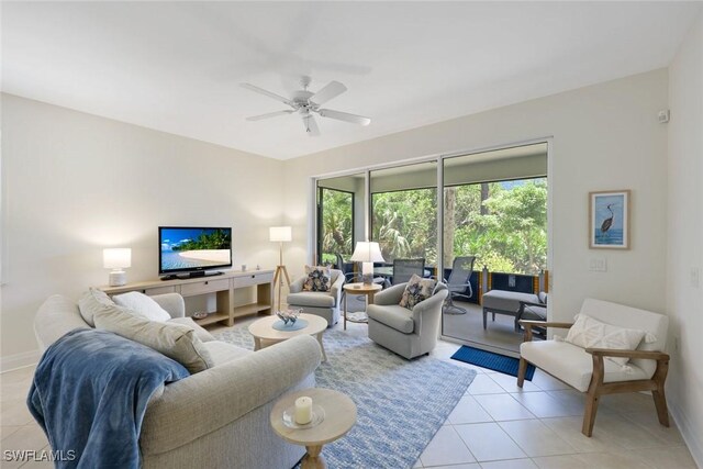 20944 Island Sound Cir Unit 101, Estero, FL 33928 - living area featuring light tile patterned floors, plenty of natural light, a ceiling fan, and baseboards