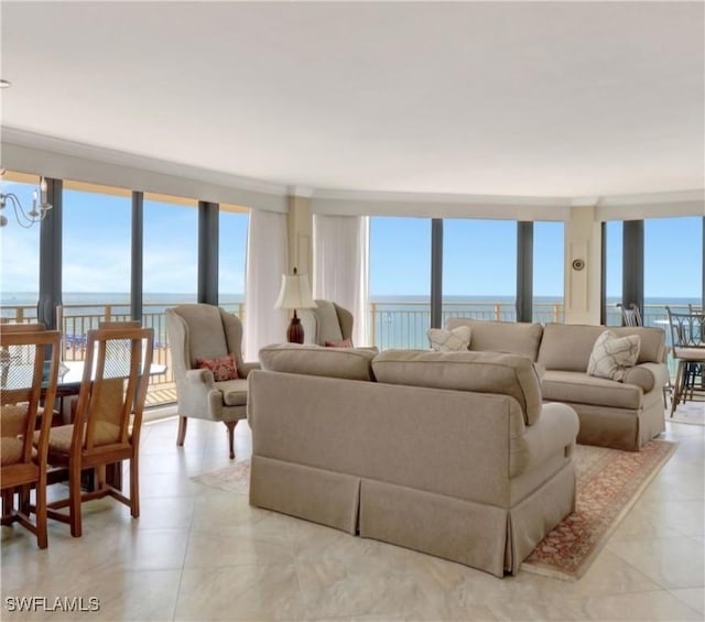 living room with a water view, floor to ceiling windows, and a notable chandelier