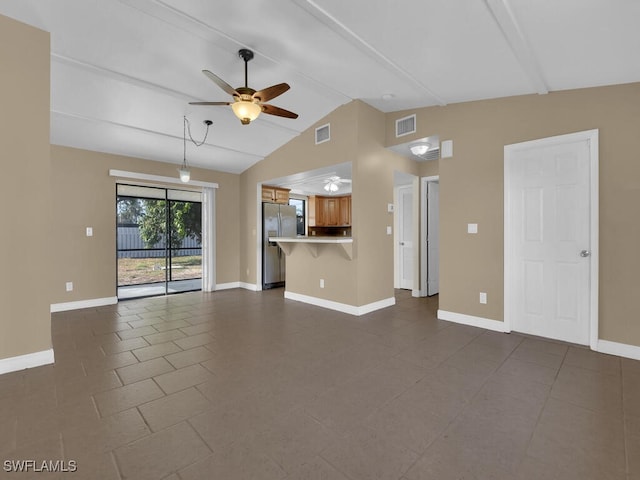 unfurnished living room featuring ceiling fan, dark tile patterned flooring, and lofted ceiling