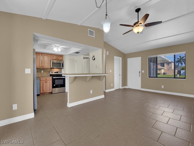 kitchen featuring lofted ceiling with beams, ceiling fan, decorative backsplash, appliances with stainless steel finishes, and a breakfast bar area