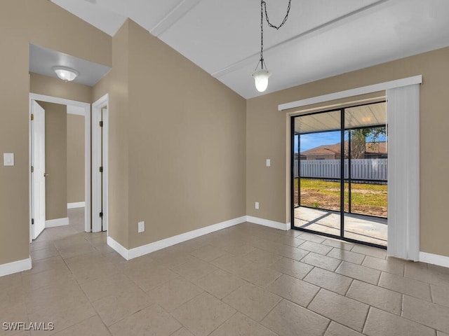 unfurnished dining area with light tile patterned flooring and vaulted ceiling