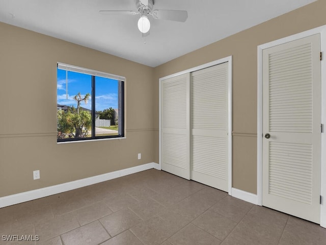 unfurnished bedroom with ceiling fan and light tile patterned floors