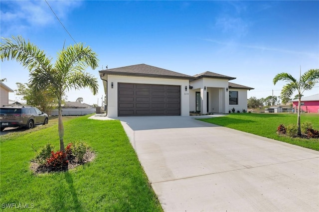 view of front of house featuring a garage and a front lawn