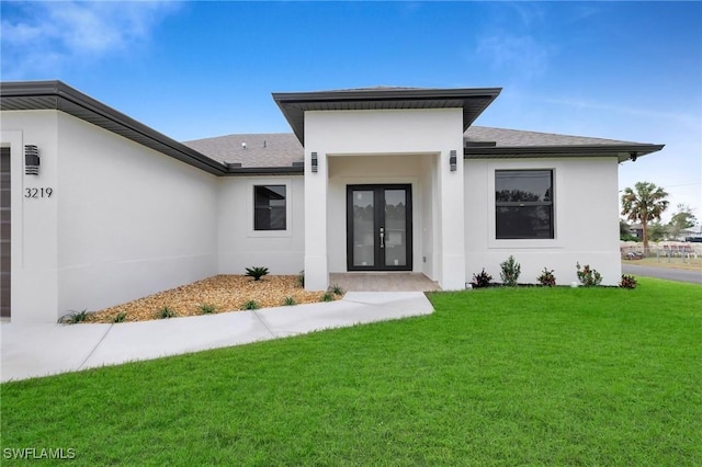 doorway to property with a yard and french doors