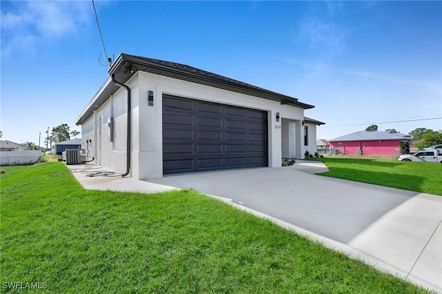 garage with a lawn and central AC