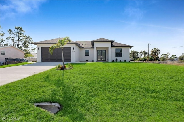 view of front of property featuring a front yard, french doors, and a garage