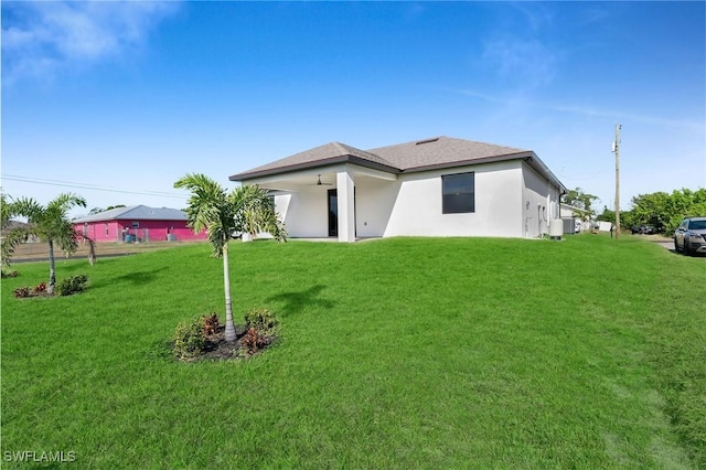 rear view of house featuring a yard