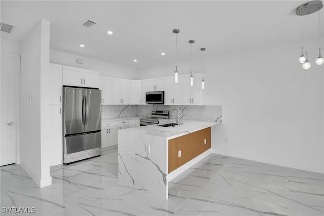 kitchen featuring white cabinets, decorative light fixtures, stainless steel appliances, and light stone countertops