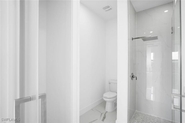 bathroom featuring a shower and toilet