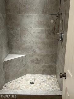 bathroom with a tile shower