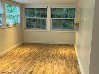 unfurnished room with light wood-type flooring