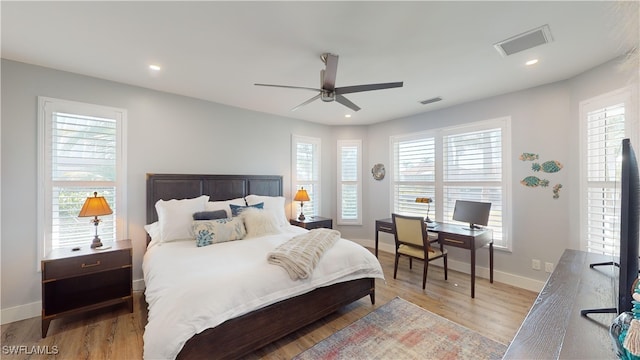 bedroom featuring baseboards, wood finished floors, visible vents, and recessed lighting