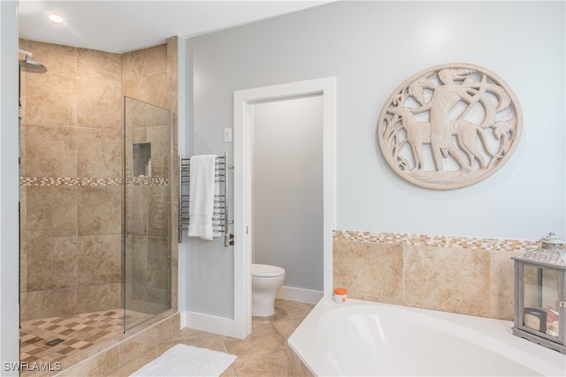 full bathroom featuring a garden tub, radiator, toilet, a stall shower, and tile patterned flooring