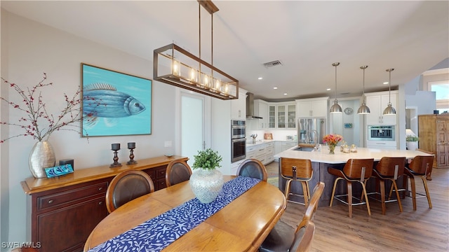 dining room featuring recessed lighting, visible vents, and light wood-style floors