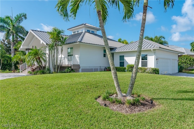90 S Seas Ct, Marco Island, FL 34145 - view of side of property featuring a garage, concrete driveway, a lawn, and a standing seam roof