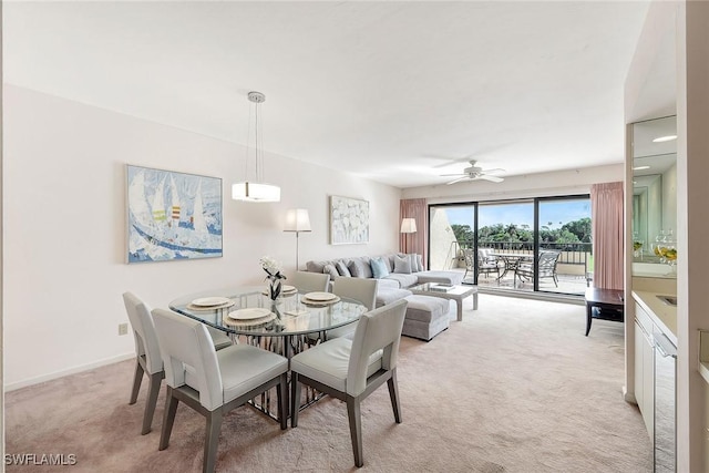 carpeted dining area featuring ceiling fan