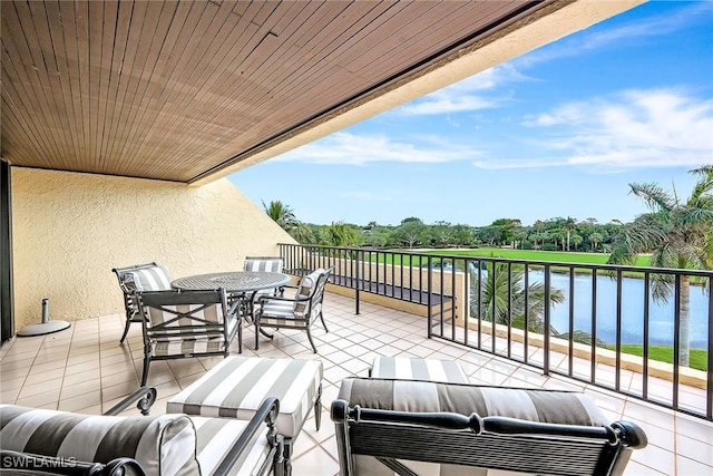 balcony featuring an outdoor living space and a water view