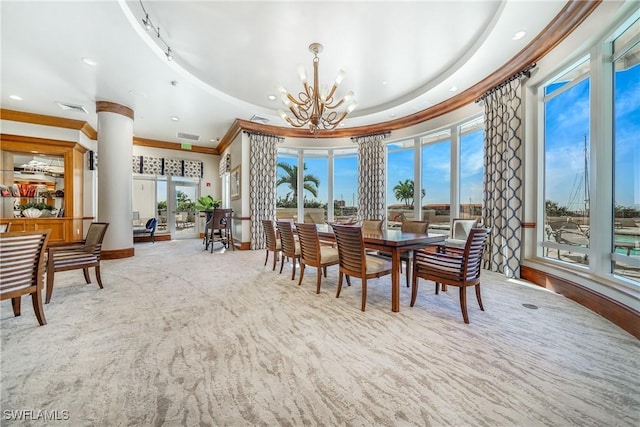 dining space with ornamental molding and an inviting chandelier