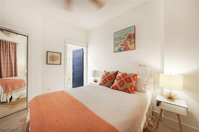 bedroom with hardwood / wood-style flooring and ceiling fan