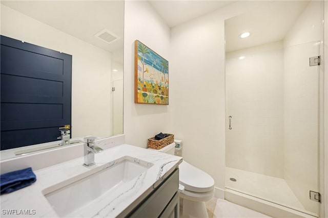 bathroom featuring an enclosed shower, vanity, and toilet