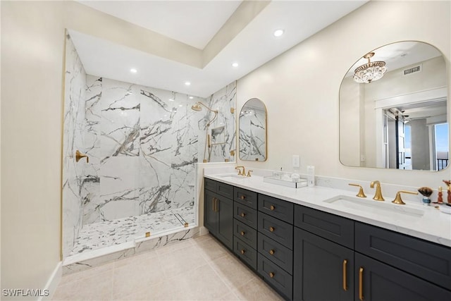 bathroom featuring a tile shower and vanity