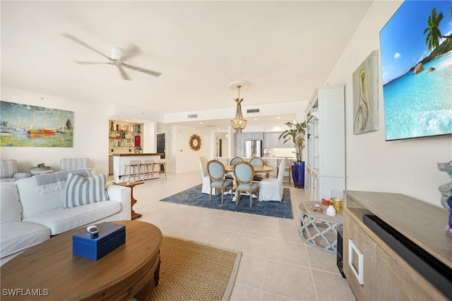 tiled living room with ceiling fan