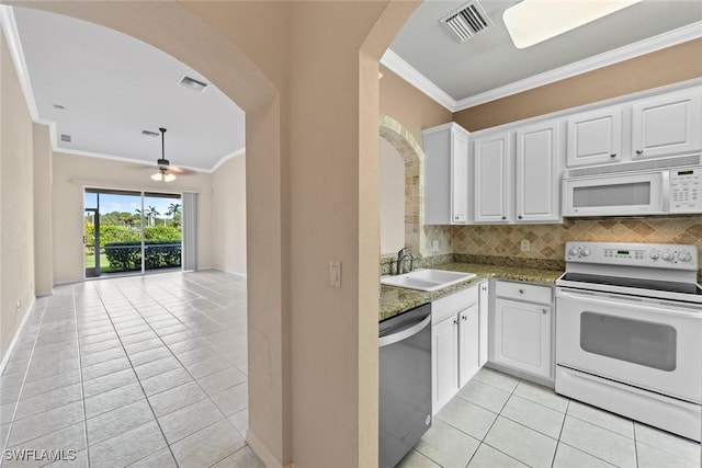 kitchen featuring white appliances, white cabinetry, and sink