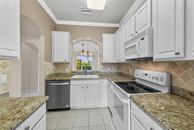 kitchen featuring white cabinetry, light stone counters, white appliances, and sink