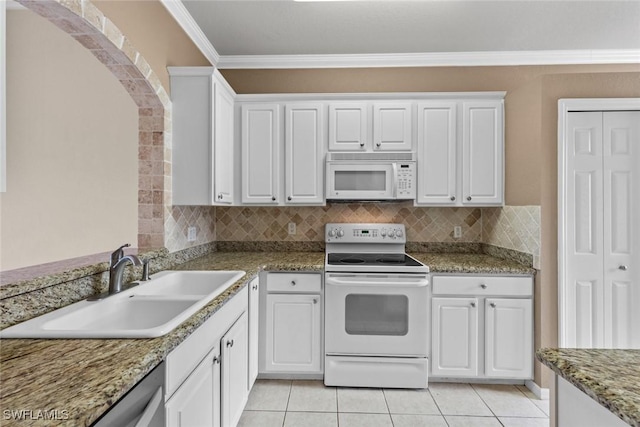 kitchen with white appliances, white cabinets, sink, ornamental molding, and light tile patterned flooring