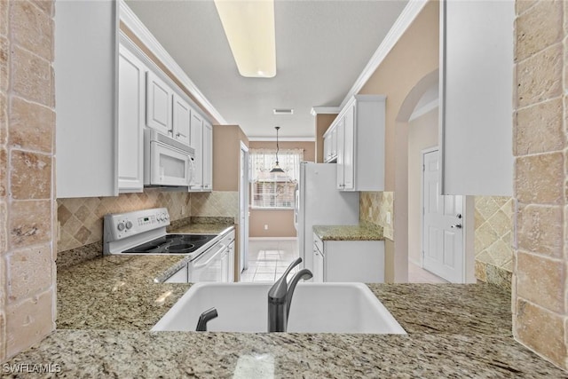 kitchen featuring white cabinetry, hanging light fixtures, tasteful backsplash, crown molding, and white appliances