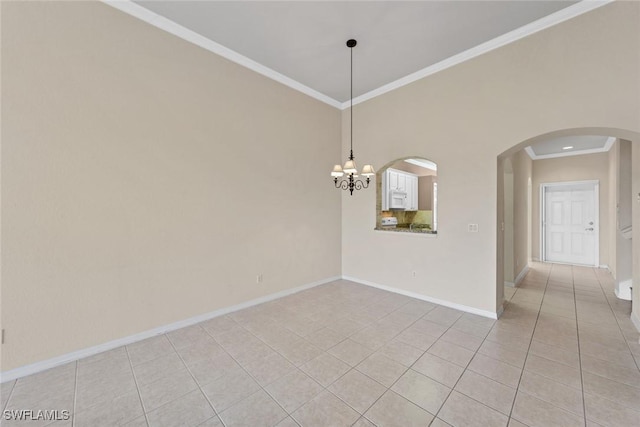 empty room featuring crown molding, light tile patterned floors, and a chandelier