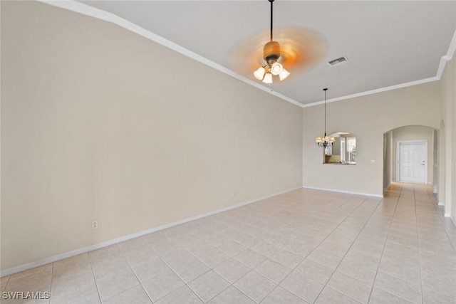 empty room featuring crown molding, light tile patterned floors, and ceiling fan with notable chandelier