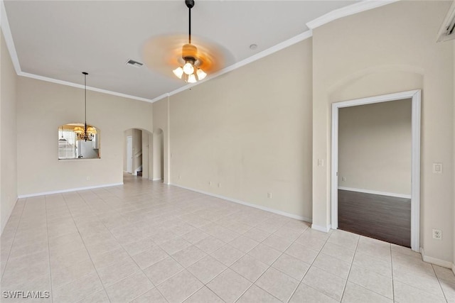 tiled spare room with ceiling fan and crown molding