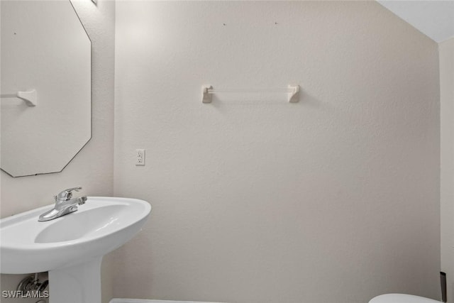 bathroom with lofted ceiling