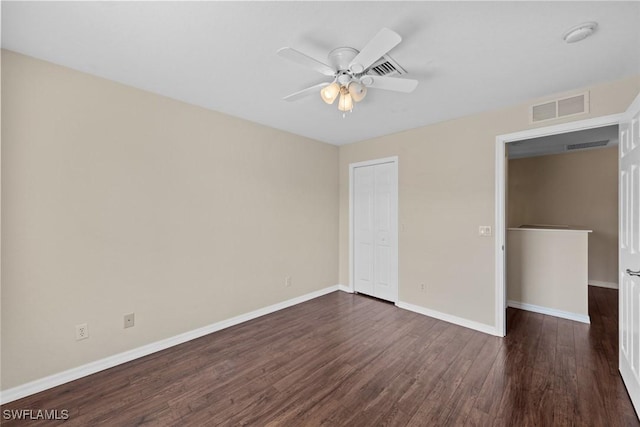 unfurnished bedroom featuring dark hardwood / wood-style flooring, a closet, and ceiling fan