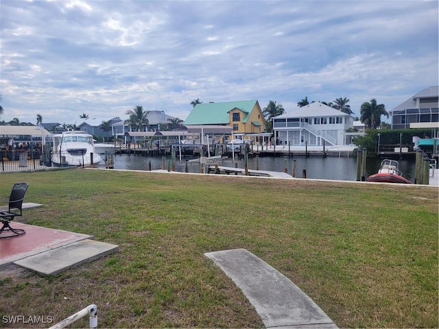 dock area with a water view and a yard