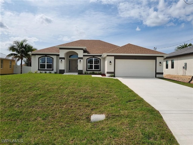 view of front of house featuring driveway, a front yard, and stucco siding