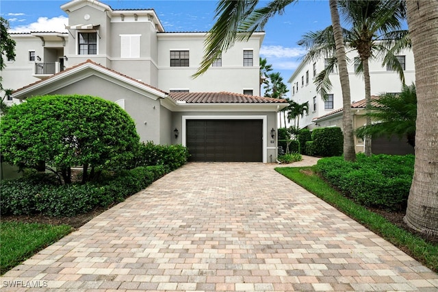 mediterranean / spanish house with a garage