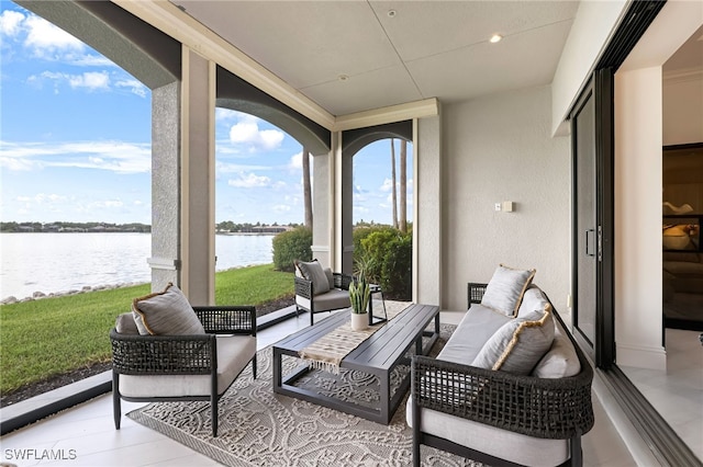 sunroom featuring a water view and a wealth of natural light