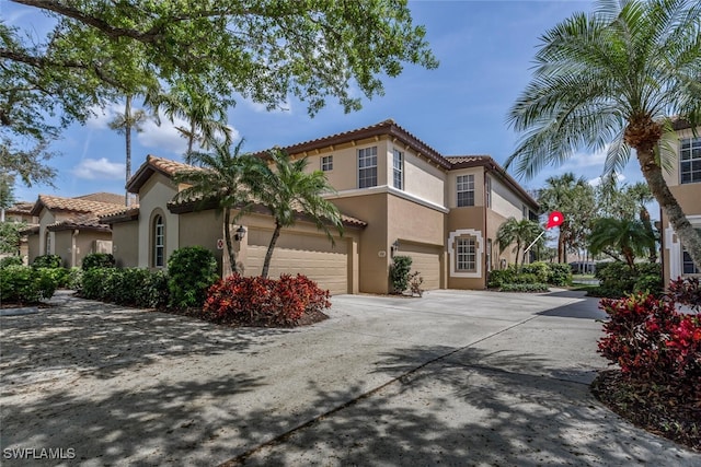 mediterranean / spanish house with a garage