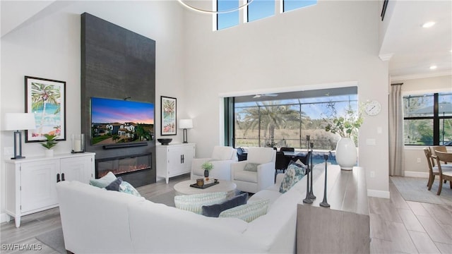 living room featuring a fireplace and a towering ceiling