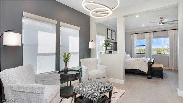 bedroom with light carpet, ceiling fan with notable chandelier, and ornamental molding