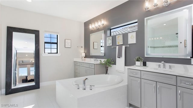 bathroom with tile patterned flooring, vanity, and shower with separate bathtub